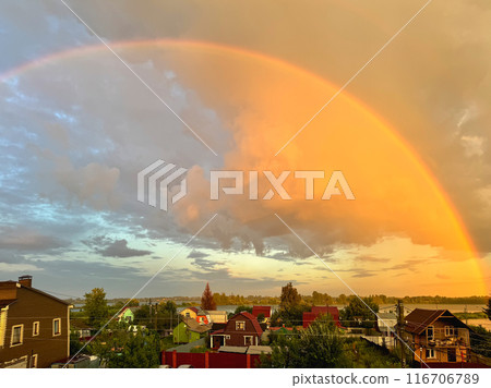 Evening sunset rainbow over the village. Evening sunset rainbow over the village. 116706789