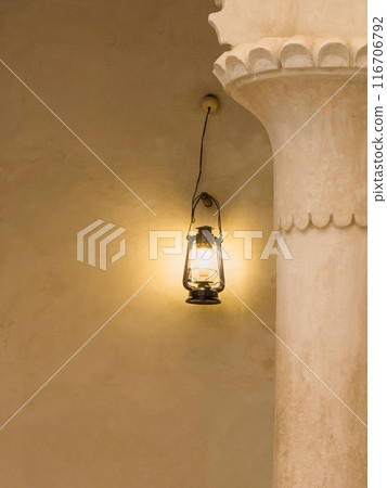 Light lamp lantern on the concrete wall next to the stucco column Light lamp lantern on the concrete wall next to the stucco column 116706792