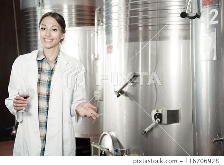 woman sommelier is tasting wine at wine factory 116706928