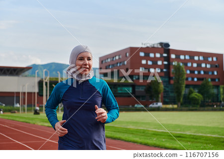 A muslim woman in a burqa sports muslim clothes running on a marathon course and preparing for upcoming competitions A muslim woman in a burqa sports muslim clothes running on a marathon course and preparing for upcoming competitions 116707156