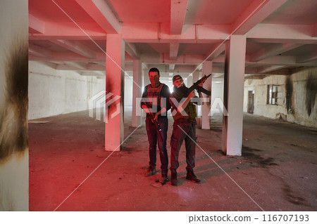 An abandoned building serves as the stronghold for a team of terrorists, fiercely guarding their occupied territory with guns and military equipment 116707193