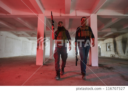 An abandoned building serves as the stronghold for a team of terrorists, fiercely guarding their occupied territory with guns and military equipment 116707327