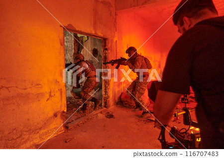 A professional cameraman captures the intense moments as a group of skilled soldiers embarks on a dangerous mission inside an abandoned building, their actions filled with suspense and bravery A professional cameraman captures the intense moments as a group of skilled soldiers embarks on a dangerous mission inside an abandoned building, their actions filled with suspense and bravery 116707483