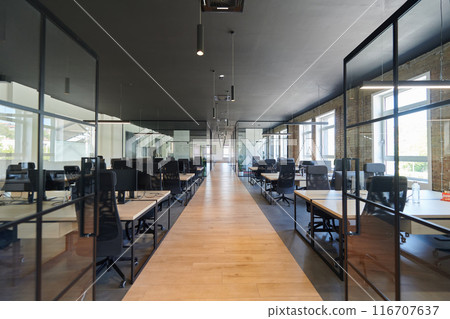 In a setting of modern, glass-walled business startup offices, the open, airy workspace reflects a contemporary and innovative ambiance, promising a dynamic environment for entrepreneurial growth 116707637