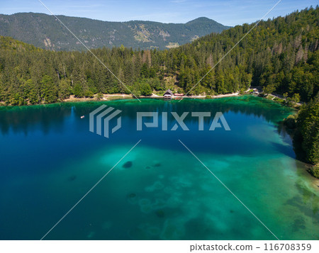 Drone shot flying. Lago Inferiore di Fusine Lake in Italy. Boat. 116708359