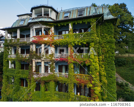 Drone shot flying. Slovenia. Green building. 116708361