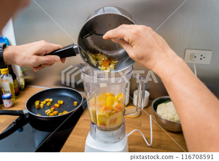 Chef at the kitchen preparing pumpkin porridge with tofu and vegetables 116708591