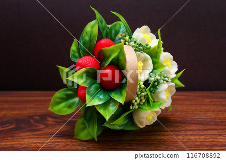 Bouquet of artificial flowers made of soap on a dark background 116708892