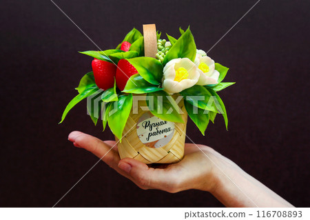 Bouquet of artificial flowers made of soap on a dark background on a woman's hand, Text in Russian - Handmade Bouquet of artificial flowers made of soap on a dark background on a woman's hand, Text in Russian - Handmade 116708893