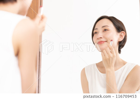 Beauty: Woman putting on makeup Beauty: Woman putting on makeup 116709453