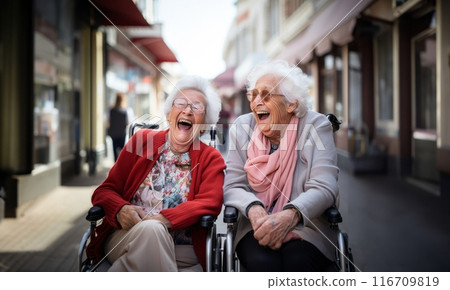 In a nursing home, two elderly women in wheelchairs find joy and companionship, embracing the comfort of their shared moments.Generated image 116709819