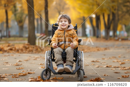 A beautiful young boy in a wheelchair enjoys a serene autumn day, surrounded by vibrant foliage in the park, embracing the wonders of nature with joy and curiosity.Generated image 116709820