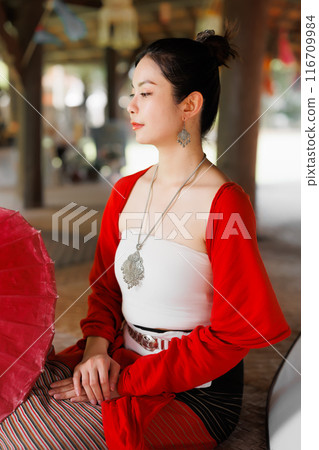 Northern Thai Chiangmai lanna people in traditional style clothes beautiful women old vintage dressing with paper umbrella at wat ton kwen. 116709984