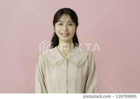 Portrait of a young woman on a pink background Portrait of a young woman on a pink background 116709995