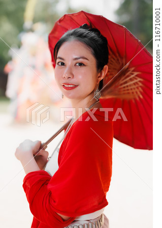Northern Thai Chiangmai lanna people in traditional style clothes beautiful women old vintage dressing with paper umbrella at wat ton kwen. 116710001