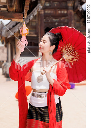 Northern Thai Chiangmai lanna people in traditional style clothes beautiful women old vintage dressing with paper umbrella at wat ton kwen. 116710002
