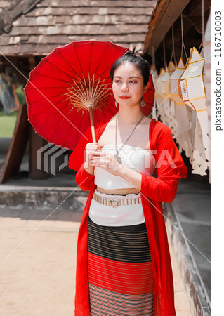 Northern Thai Chiangmai lanna people in traditional style clothes beautiful women old vintage dressing with paper umbrella at wat ton kwen. 116710003