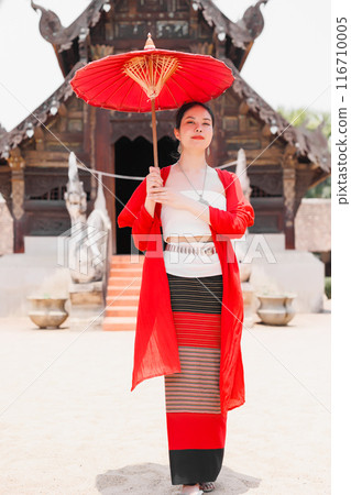 Northern Thai Chiangmai lanna people in traditional style clothes beautiful women old vintage dressing with paper umbrella at wat ton kwen. 116710005