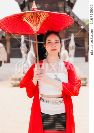 Northern Thai Chiangmai lanna people in traditional style clothes beautiful women old vintage dressing with paper umbrella at wat ton kwen. 116710006