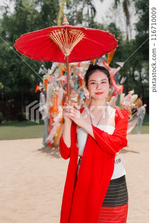 Northern Thai Chiangmai lanna people in traditional style clothes beautiful women old vintage dressing with paper umbrella at wat ton kwen. 116710009