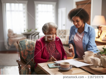 A symbolic portrayal depicts a nursing sister providing compassionate care to an elderly lady in a nursing home, offering not just medical assistance but also warm conversation and a comforting A symbolic portrayal depicts a nursing sister providing compassionate care to an elderly lady in a nursing home, offering not just medical assistance but also warm conversation and a comforting 116710378