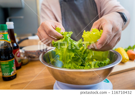 Chef at the kitchen preparing spicy glass noodle salad Chef at the kitchen preparing spicy glass noodle salad 116710432