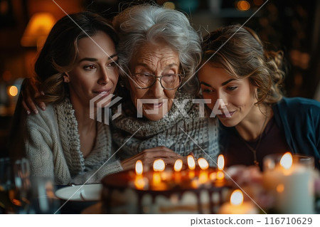Grandmother surrounded by grandchildren with birthday cake. Love through generations. 116710629