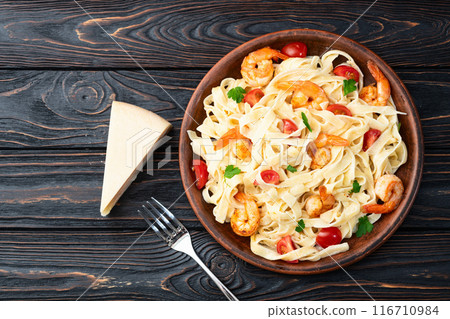 Italian pasta with shrimps , parmesan and tomatoes 116710984