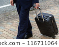 Businessman walking down the sidewalk with a suitcase 116711064