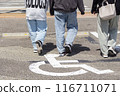 Family walking through a parking lot 116711071
