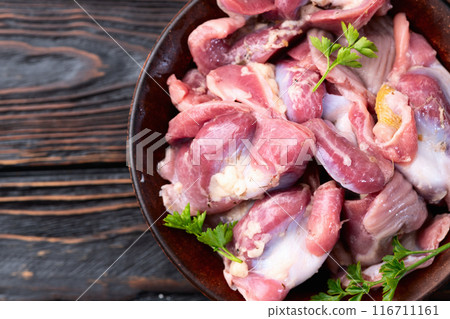 Raw chicken giblets gizzard ( stomach ) , meat background 116711161