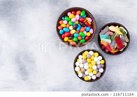 Mix of colorful candies . Multicolored unhealthy background. Sweet dessert Mix of colorful candies . Multicolored unhealthy background. Sweet dessert 116711184