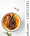 Lamb shoulder slow cooked  in a cast iron pan 116711391