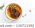 Lamb shoulder braised in a cast iron pan 116711392