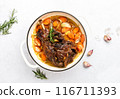 Lamb shoulder braised in a cast iron pan 116711393