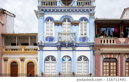 Street view with facades of old colonial buildings in Quito, Ecuador. 116711491
