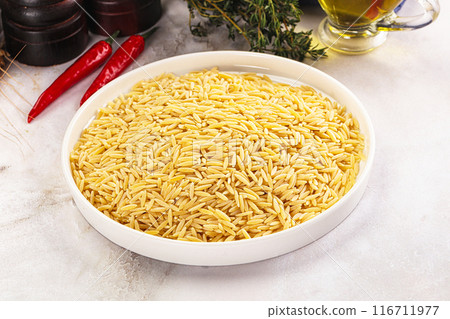 Italian raw dry pasta risoni 116711977