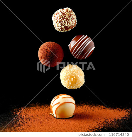 Assortment of rich chocolate bonbons, cut out on black background Assortment of rich chocolate bonbons, cut out on black background 116714240