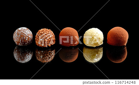 Assortment of rich chocolate bonbons, cut out on black background Assortment of rich chocolate bonbons, cut out on black background 116714248