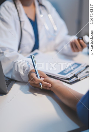 Doctor working in the office and listening to the patient, she is explaining her symptoms, healtcare and assistance concept Doctor working in the office and listening to the patient, she is explaining her symptoms, healtcare and assistance concept 116714357