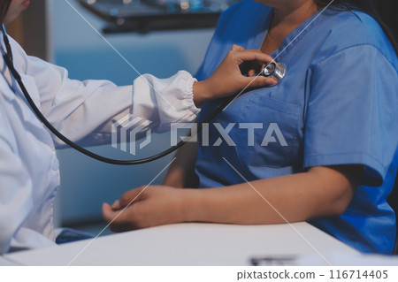 Asian female medical doctor use stethoscope to listen examine check senior elderly patient heart 116714405