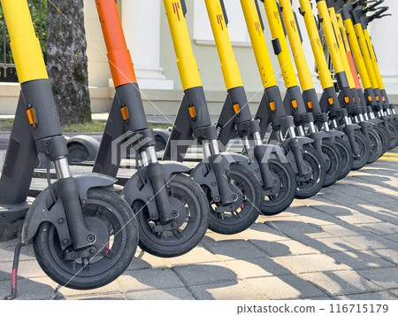 "Modern urban transportation options like e-scooters and bicycles, highlighting rental and shared "Modern urban transportation options like e-scooters and bicycles, highlighting rental and shared 116715179