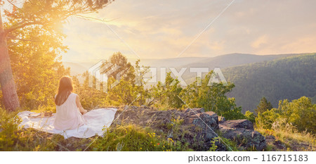 Woman in white dress sitting on rock in forest valley at sunset, radiating bliss and tranquility Woman in white dress sitting on rock in forest valley at sunset, radiating bliss and tranquility 116715183