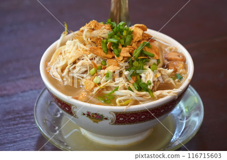 a bowl of soto kudus, a traditional Indonesian vegetable and noodle soup. a bowl of soto kudus, a traditional Indonesian vegetable and noodle soup. 116715603