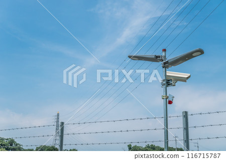 Barbed wire and security cameras to prevent trespassers Barbed wire and security cameras to prevent trespassers 116715787