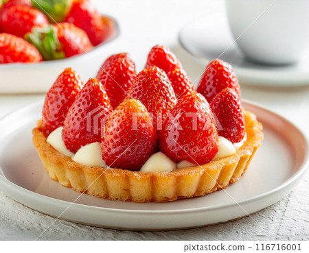 Strawberry and custard cream tart on a white table background Strawberry and custard cream tart on a white table background 116716001