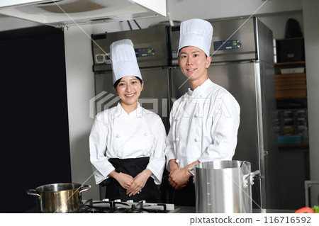 Young asian male and female chefs cooking in the kitchen Young asian male and female chefs cooking in the kitchen 116716592
