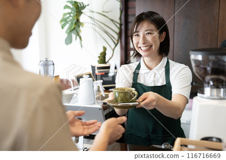 咖啡館的女店員微笑著遞咖啡 116716669