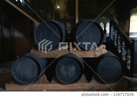 A stack of barrels are piled on top of each other 116717026