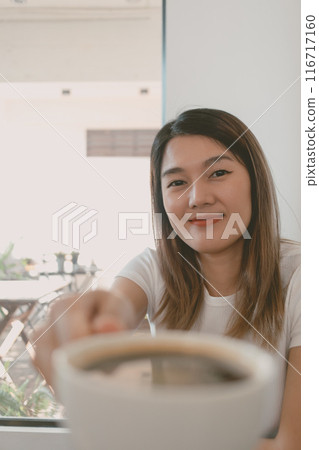 Woman is receiving a coffee cup and drink. Woman is receiving a coffee cup and drink. 116717160